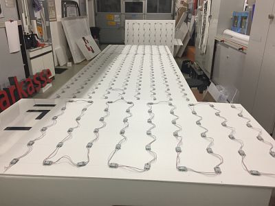 Vormontage energiesparender LED-Beleuchtungstechnik auf weißen Trägerplatten für die Umrüstung einer Großanlage von Rodath Werbetechnik